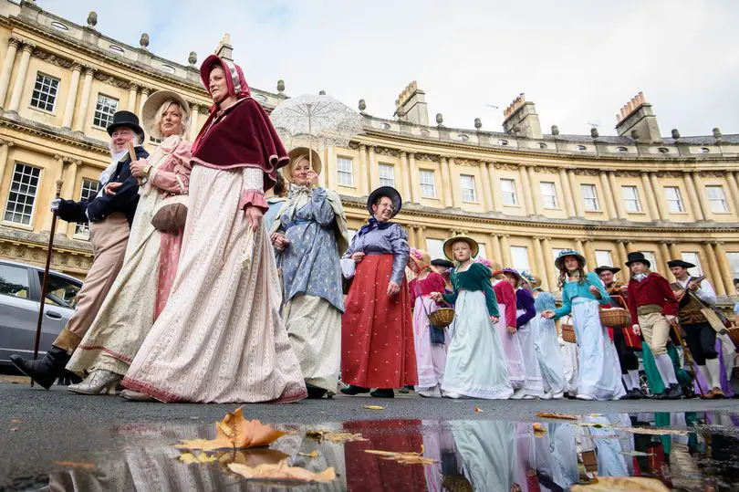 Jane Austen costumed party in front of Royal Crescent during Jane Austen Festival in Bath