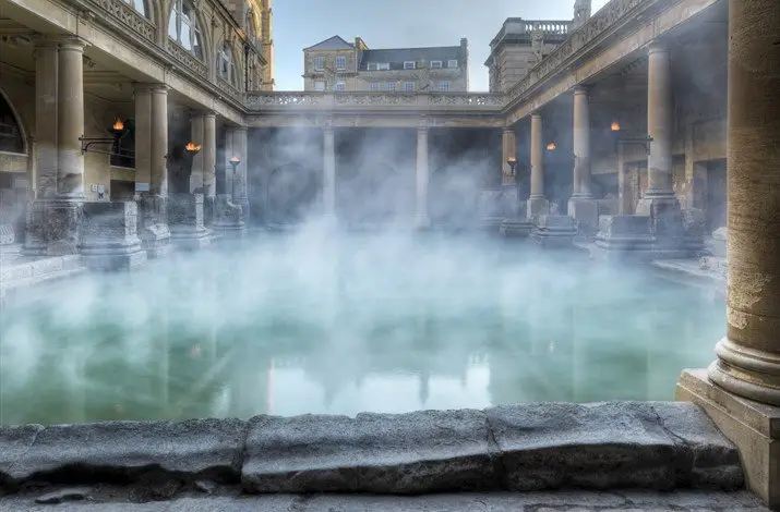 The Great Bath and its columns and steam at the Roman Baths in Bath