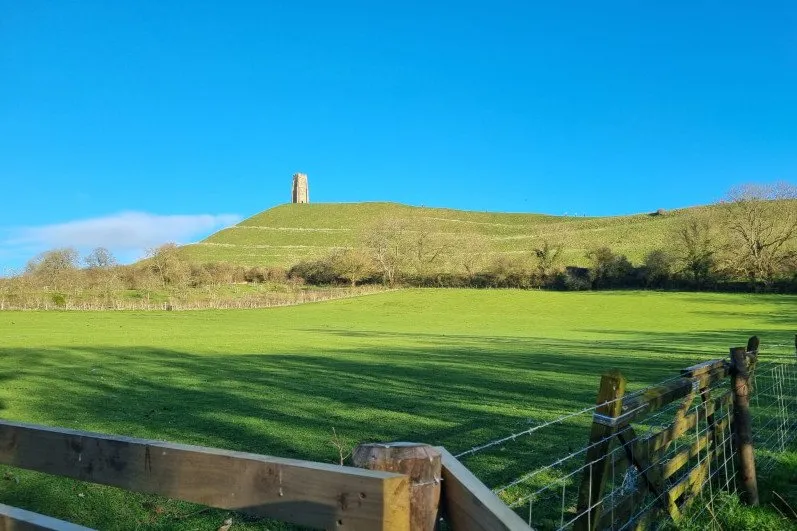 View of Glastonbury Tor set atop a conical hill in Somerset