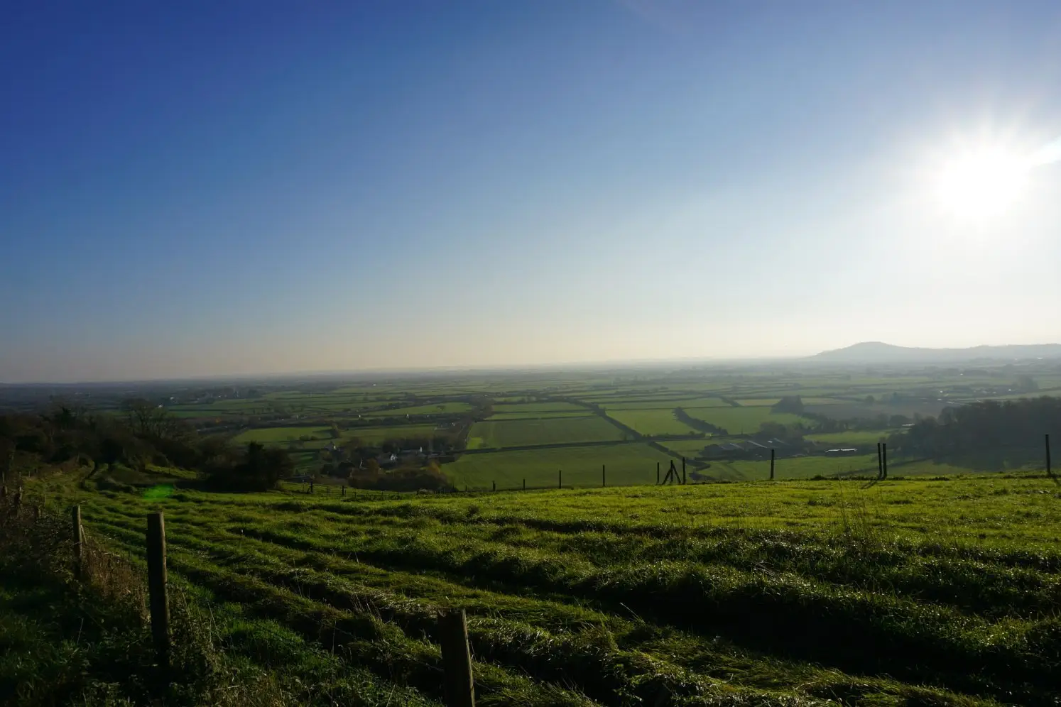 Sun shining on spectacular views from Bleadon Hill of Mendip Hills and Somerset Levels