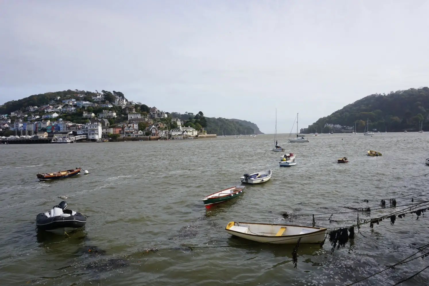 Dartmouth harbour with small boats and views of River Dart estuary and Kingwear town