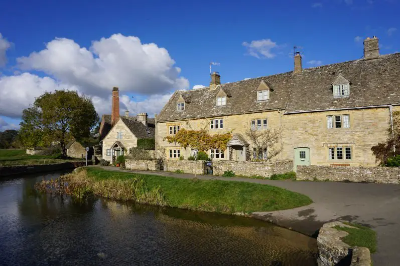 Charming street along stream in Lower Slaughter, top picturesque village in the North Cotswolds