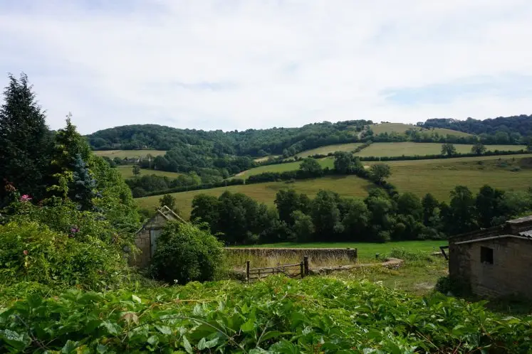 Cotswold green hills and farm houses in the hamlet of Slad