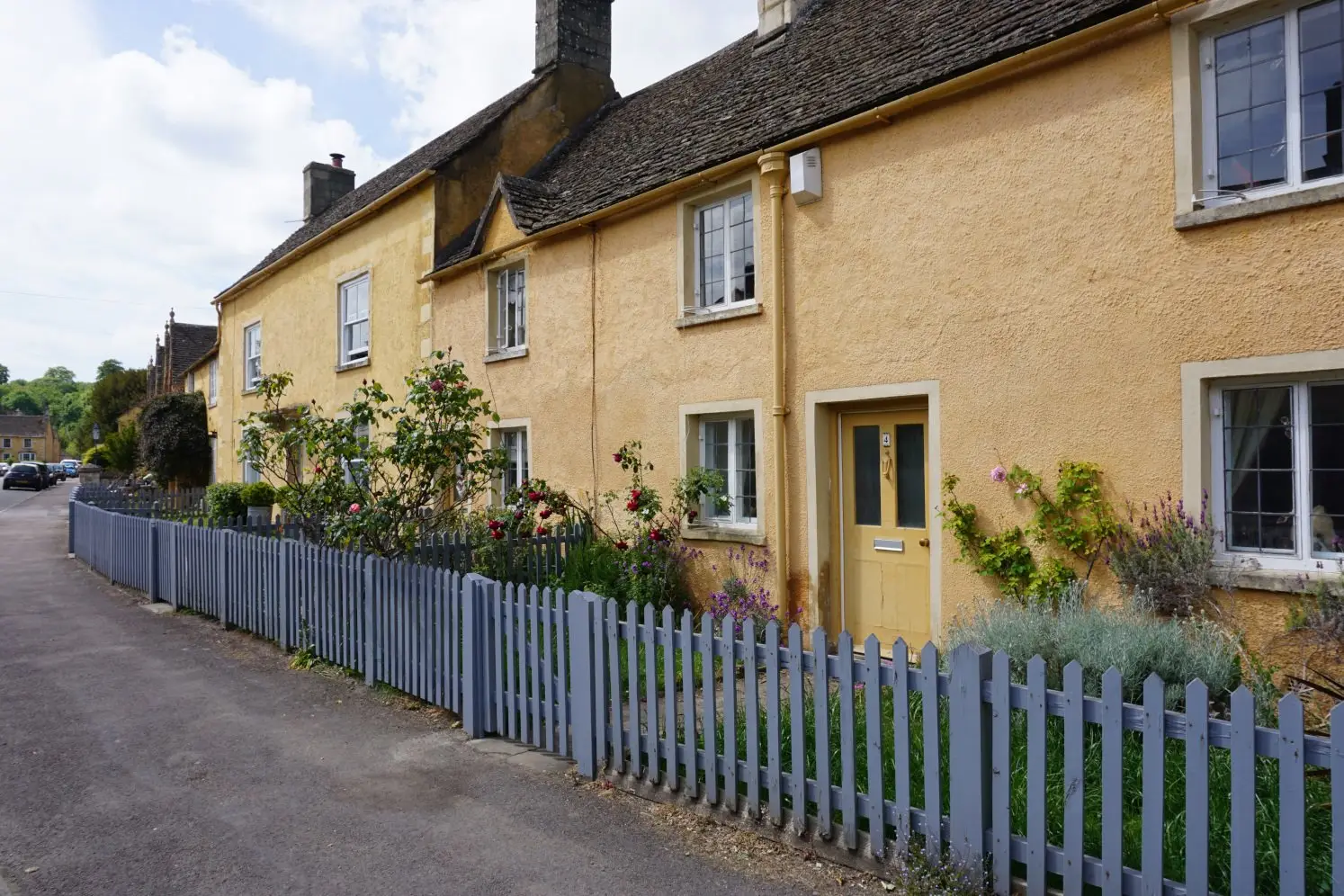 Picturesque cottages painted yellow in the Cotswold village of Badminton near Bath and Bristol