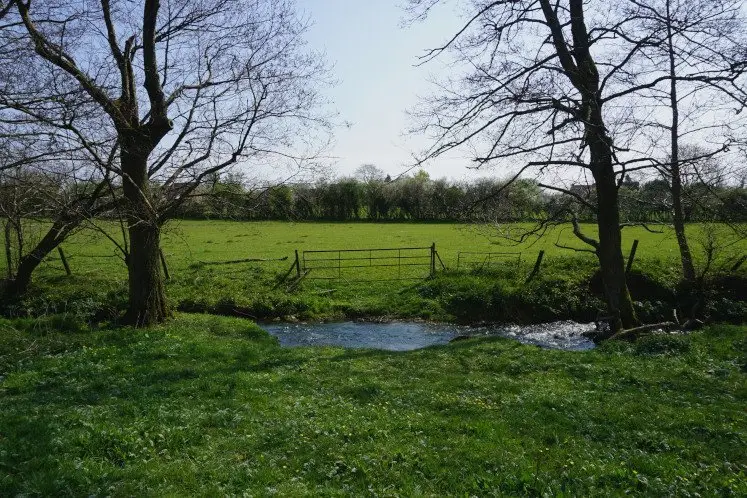 River Frome flowing across green fields near Chipping Sodbury