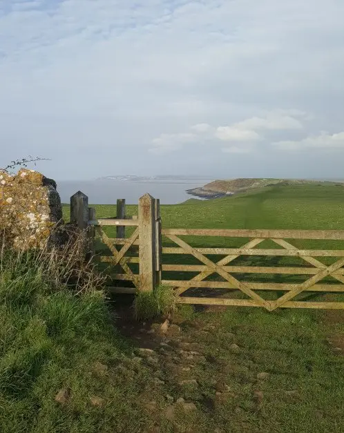 Wooden gate with view of headland and Bristol Channel in Sand Point near Bristol