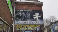 Banksy graffiti in Stokes Croft, Bristol Mild Mild West