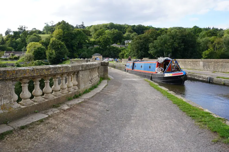 Canal boat and Kennet & Avon canal over the Dundas Aqueduct on the Bath to Bradford-on-Avon canal walk