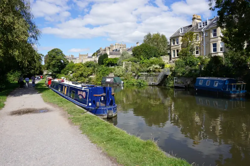 Kennet & Avon canal in Bath with colourful canal boats and Georgian town houses