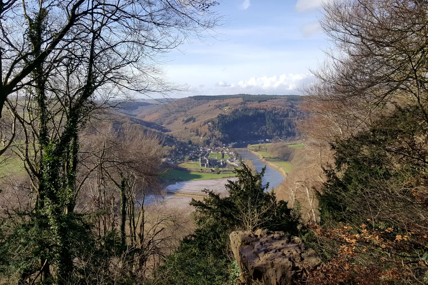 Tintern Abbey nested in the Wye Valley, viewed from the Devil's Pulprit