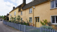 Picturesque cottages painted yellow in the Cotswold village of Badminton near Bath and Bristol